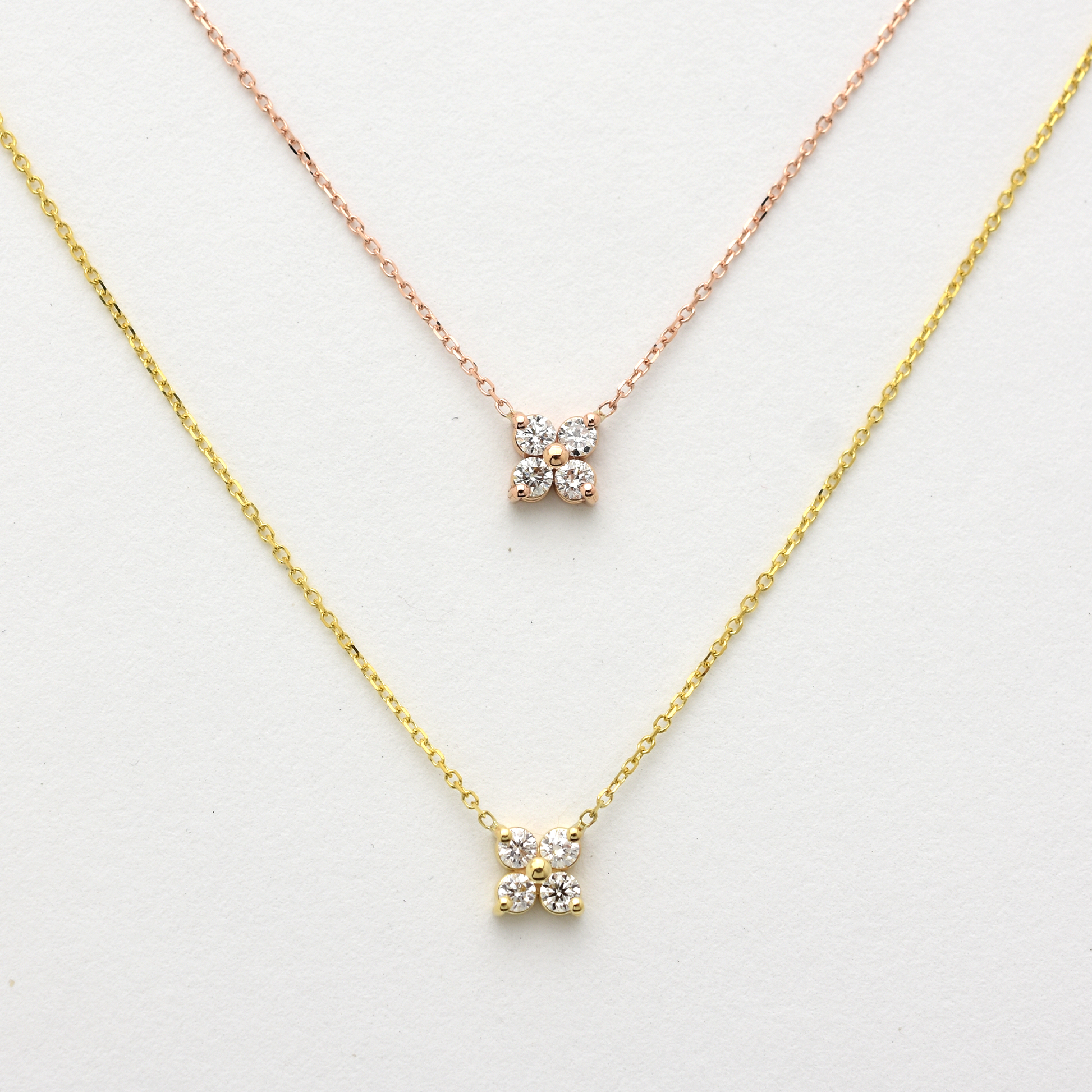 Two diamond necklaces on a white background