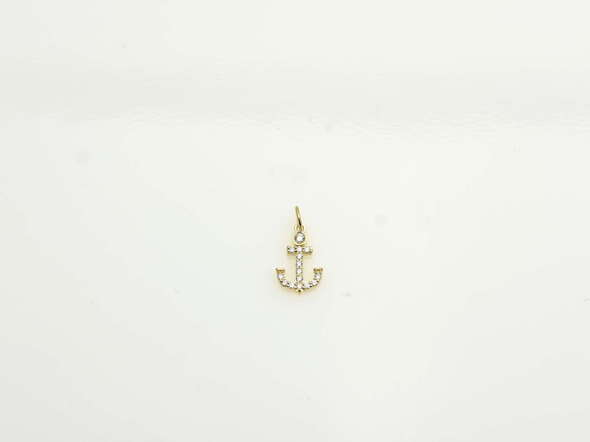 14k Gold and diamond Anchor necklace pendant with a 14k solid gold cable link chain, the diamonds are prong set and bezel set sliding on the chain displayed on a white background
