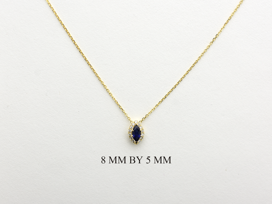  14K gold necklace featuring a marquise-cut sapphire center stone surrounded by a delicate diamond halo displayed on white background