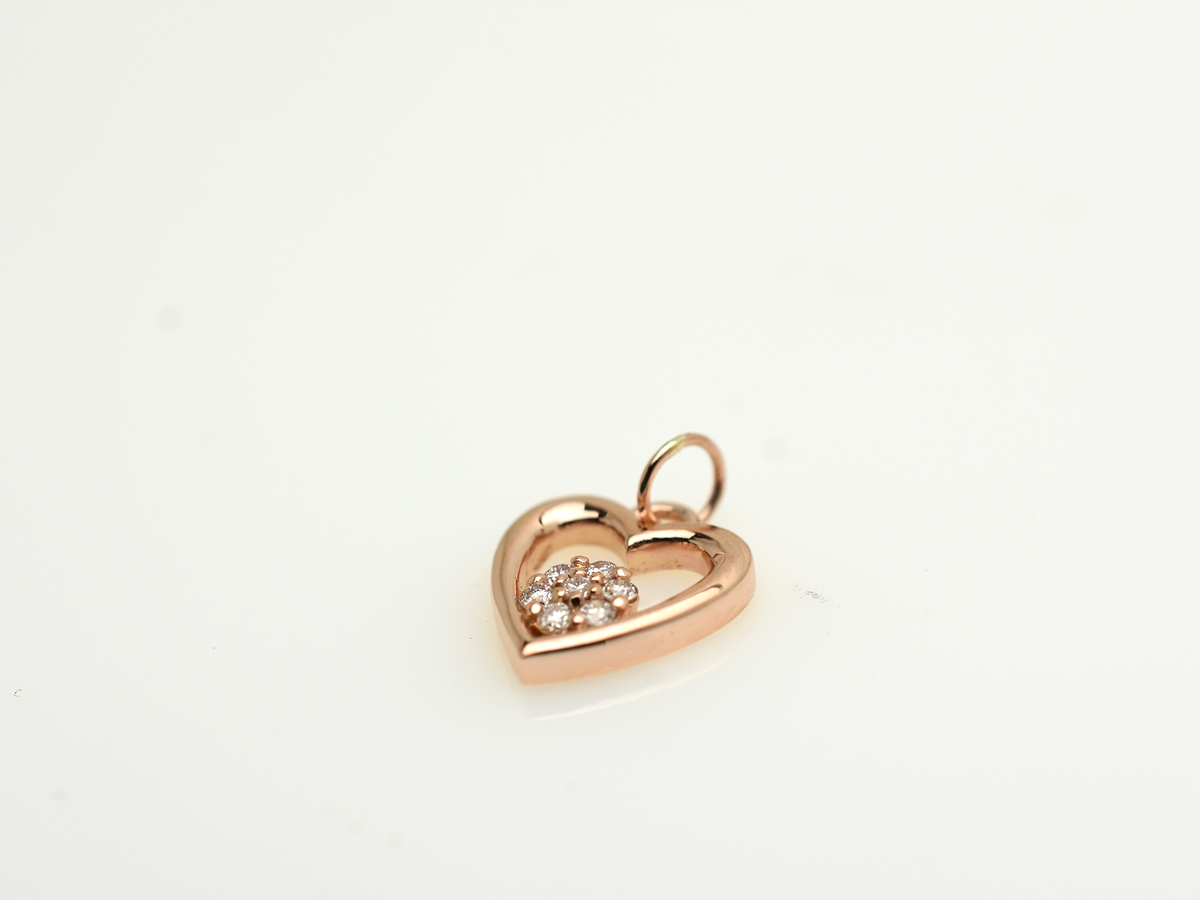 featuring a 14k gold heart necklace with a flower cluster motive 11 mm in dimension . the chain is a 14k sold gold cable link chain with a lobster lock 