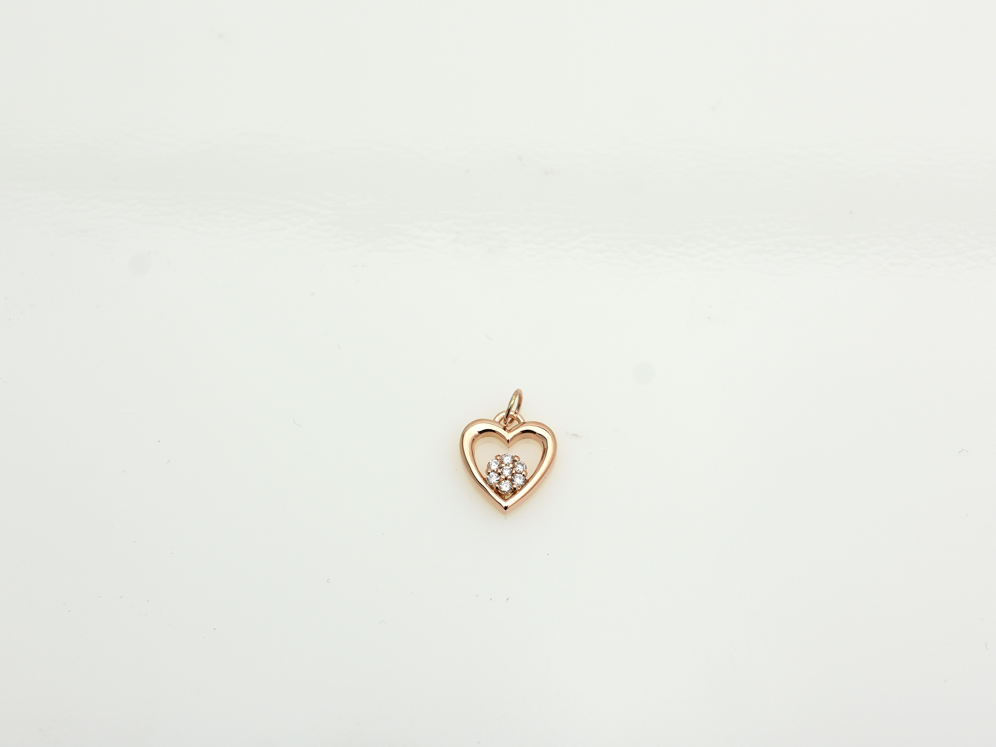 featuring a 14k gold heart necklace with a flower cluster motive 11 mm in dimension . the chain is a 14k sold gold cable link chain with a lobster lock 