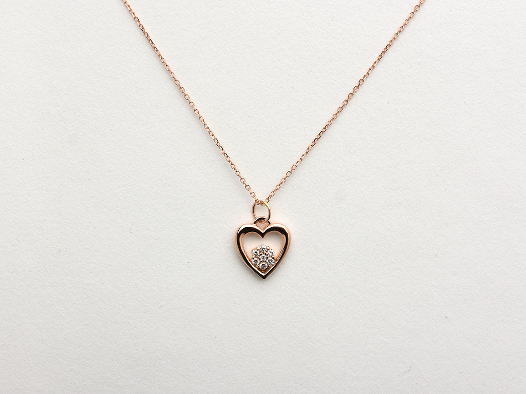 featuring a 14k gold heart necklace with a flower cluster motive 11 mm in dimension . the chain is a 14k sold gold cable link chain with a lobster lock 