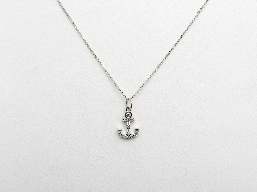 14k Gold and diamond Anchor necklace pendant with a 14k solid gold cable link chain, the diamonds are prong set and bezel set sliding on the chain displayed on a white background