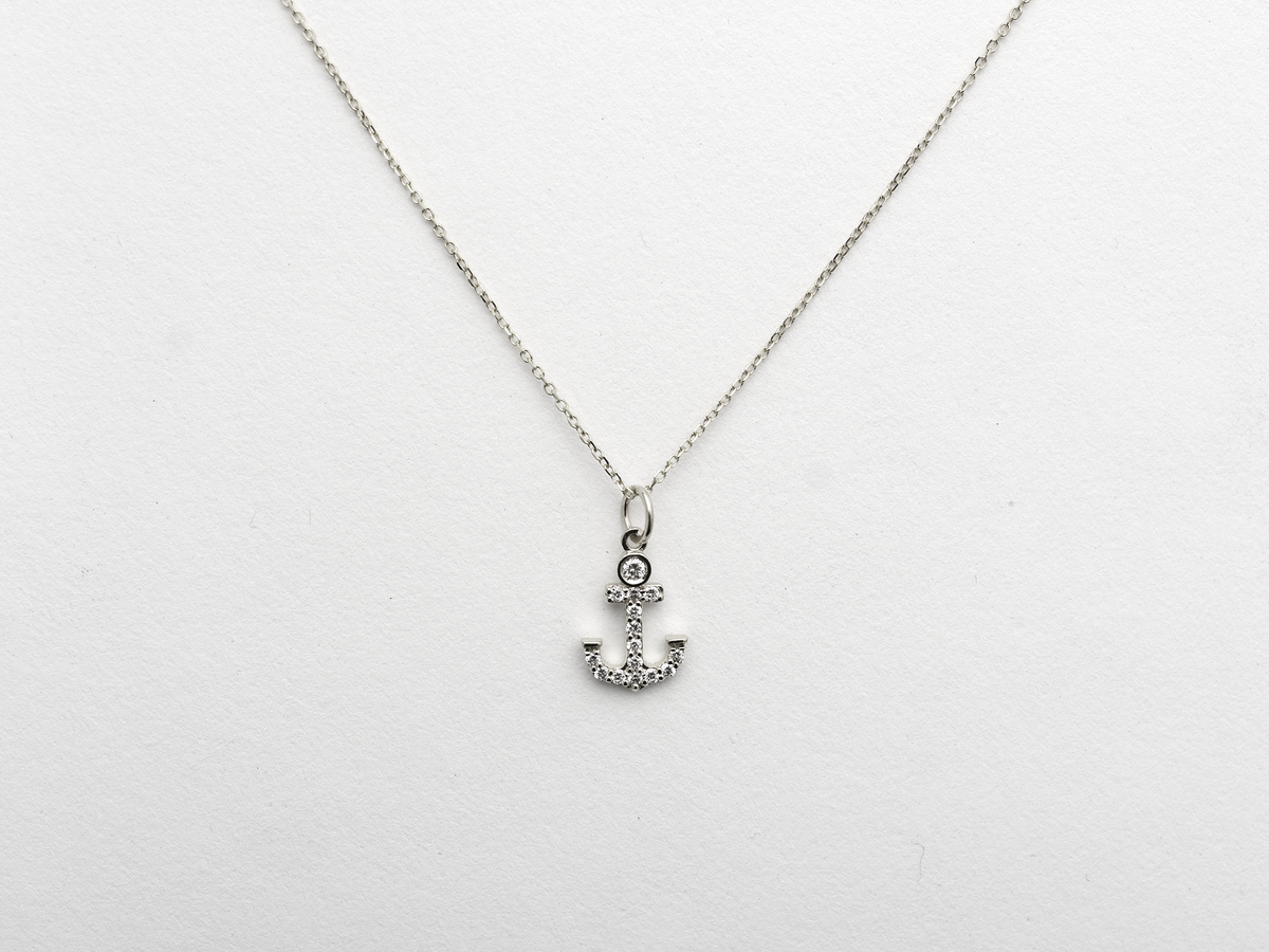 14k Gold and diamond Anchor necklace pendant with a 14k solid gold cable link chain, the diamonds are prong set and bezel set sliding on the chain displayed on a white background