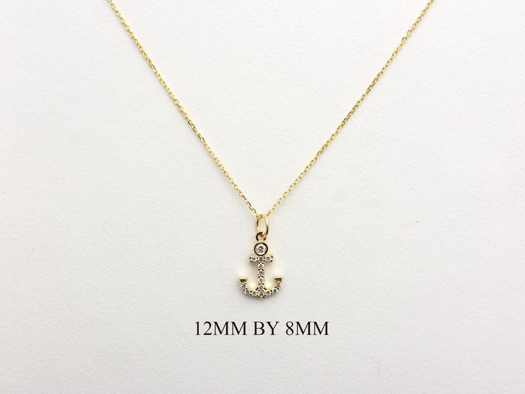 14k Gold and diamond Anchor necklace pendant with a 14k solid gold cable link chain, the diamonds are prong set and bezel set sliding on the chain displayed on a white background
