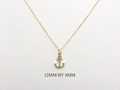 14k Gold and diamond Anchor necklace pendant with a 14k solid gold cable link chain, the diamonds are prong set and bezel set sliding on the chain displayed on a white background