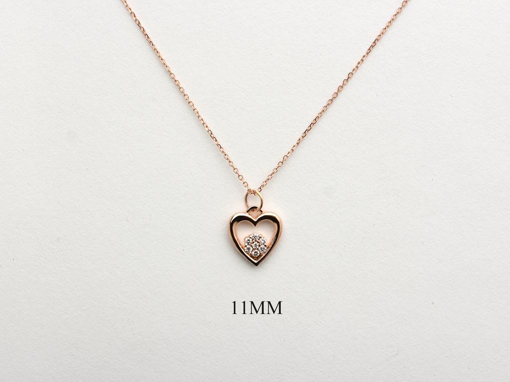 featuring a 14k gold heart necklace with a flower cluster motive 11 mm in dimension . the chain is a 14k sold gold cable link chain with a lobster lock 