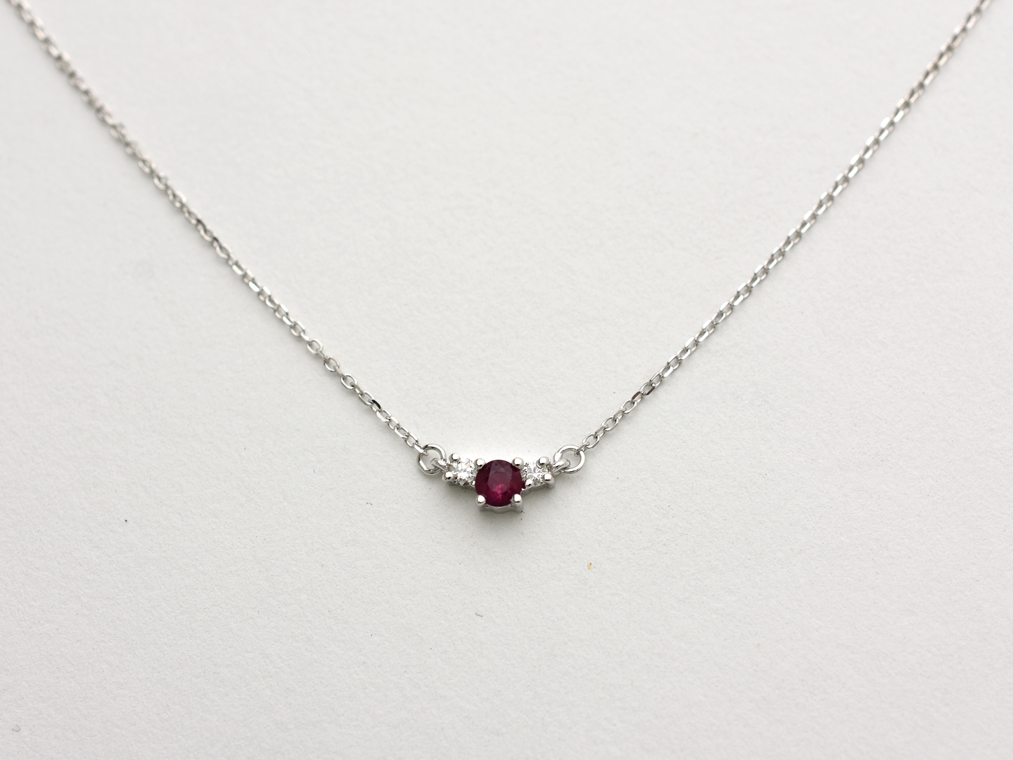 14k gold diamond and ruby necklace . past present and future design mini size pendant. the chain is a 0.8 mm cable link chain dainty and everyday look on a white background