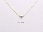  featuring a dainty three-stone diamond cluster pendant. The centerpiece consists of one slightly larger round brilliant cut stone flanked by two smaller stones in a minimalist prong setting on a fine gold cable chain with a lobster claw clasp