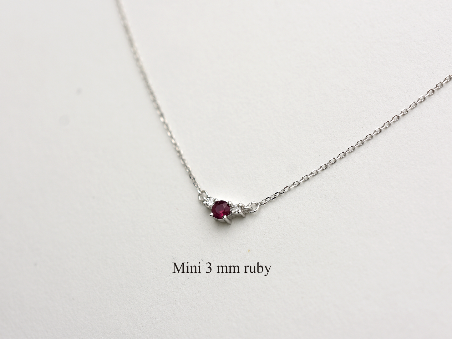 14k gold diamond and ruby necklace . past present and future design mini size pendant. the chain is a 0.8 mm cable link chain dainty and everyday look on a white background