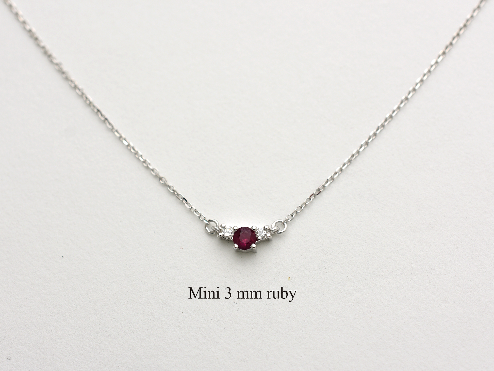 14k gold diamond and ruby necklace . past present and future design mini size pendant. the chain is a 0.8 mm cable link chain dainty and everyday look on a white background