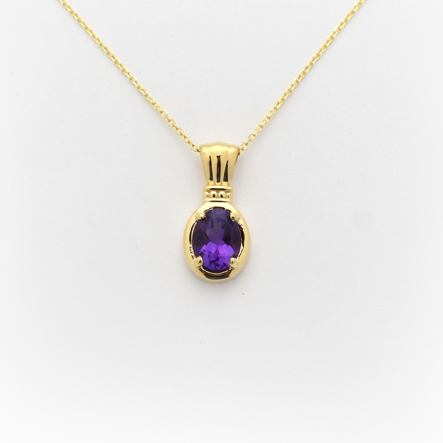 A 14k gold oval amethyst necklace with a lobster lock on a white background.