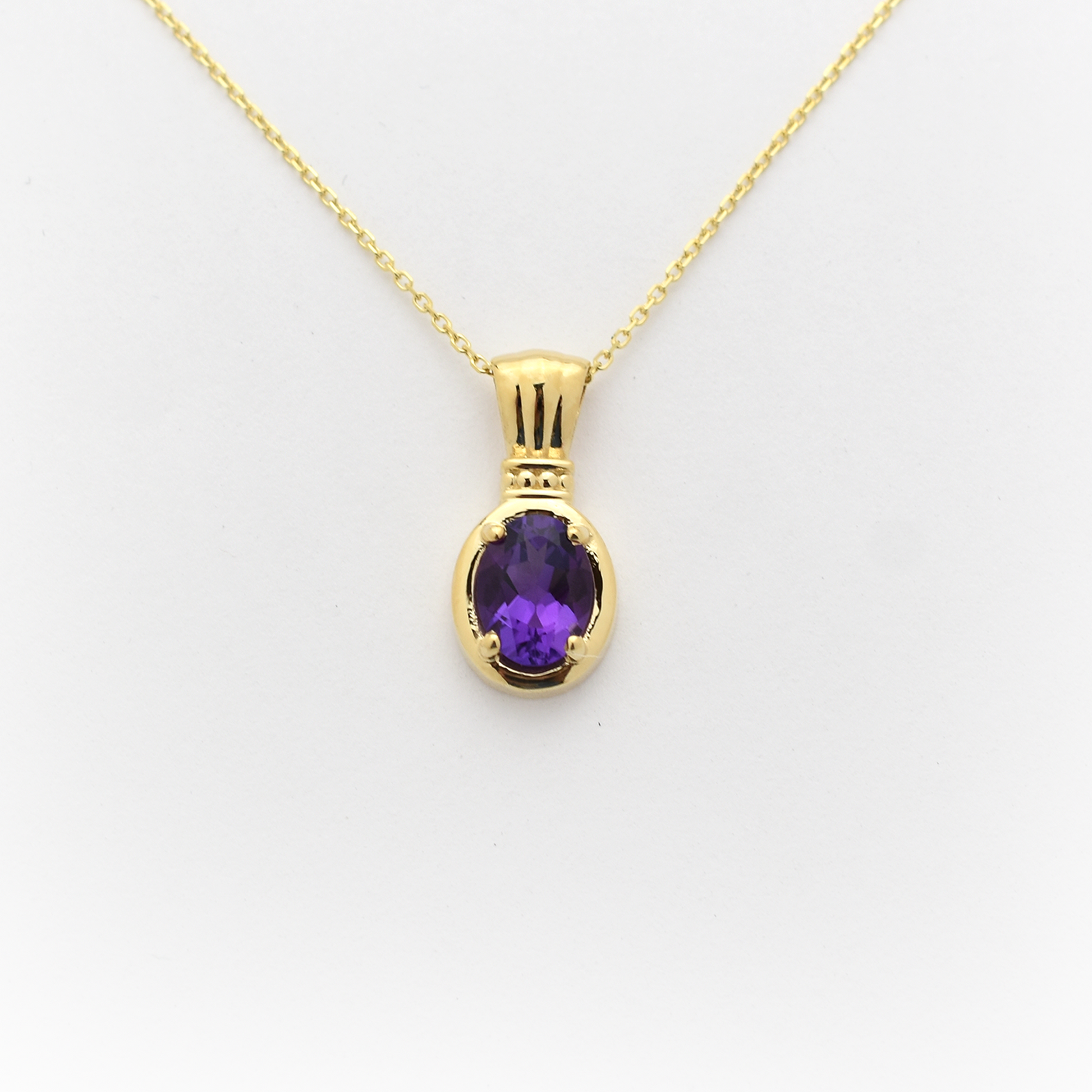 A 14k gold oval amethyst necklace with a lobster lock on a white background.