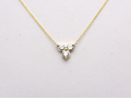 14k yellow gold necklace with a three-stone pendant of round brilliant cut 0.60  carat diamonds  on a white background