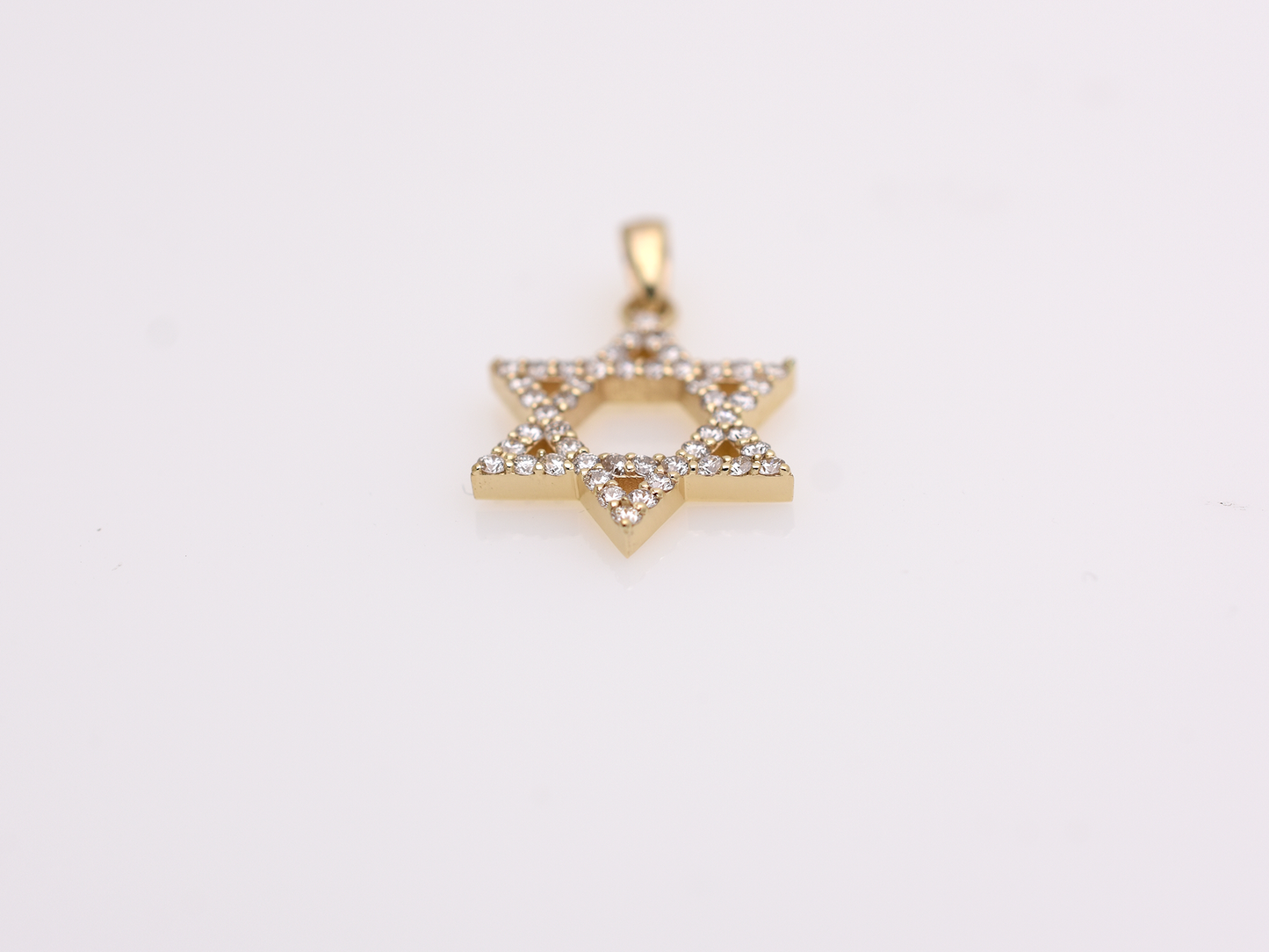 A gold-colored necklace with a Star of David pendant. The pendant is 15 mm in size and is encrusted with small, clear gemstones. The chain is delicate and hangs against a white background.