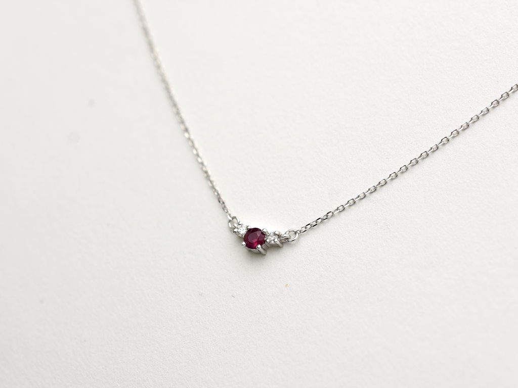 14k gold diamond and ruby necklace . past present and future design mini size pendant. the chain is a 0.8 mm cable link chain dainty and everyday look on a model