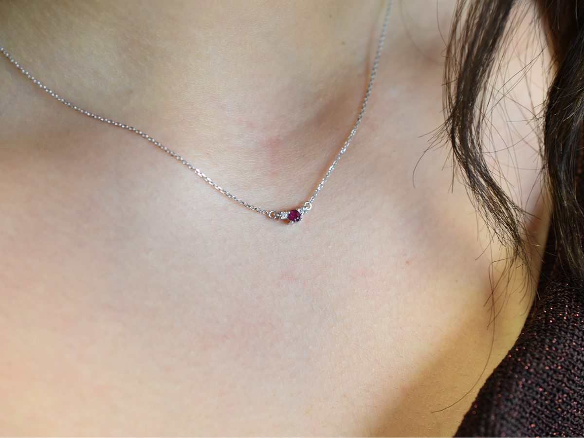 14k gold diamond and ruby necklace . past present and future design mini size pendant. the chain is a 0.8 mm cable link chain dainty and everyday look on a model