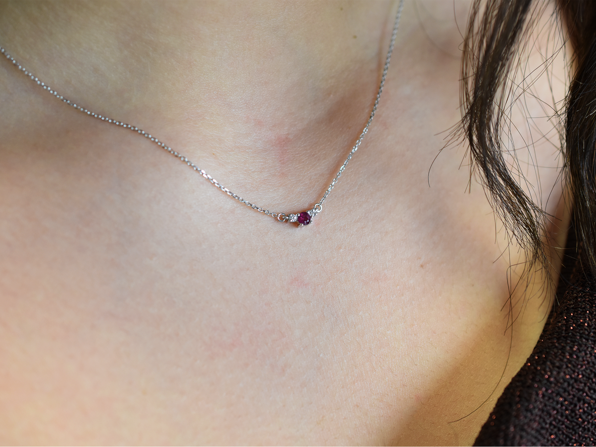 14k gold diamond and ruby necklace . past present and future design mini size pendant. the chain is a 0.8 mm cable link chain dainty and everyday look on a model