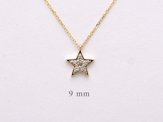 Dainty 14k gold diamond star necklace displayed on a white background.