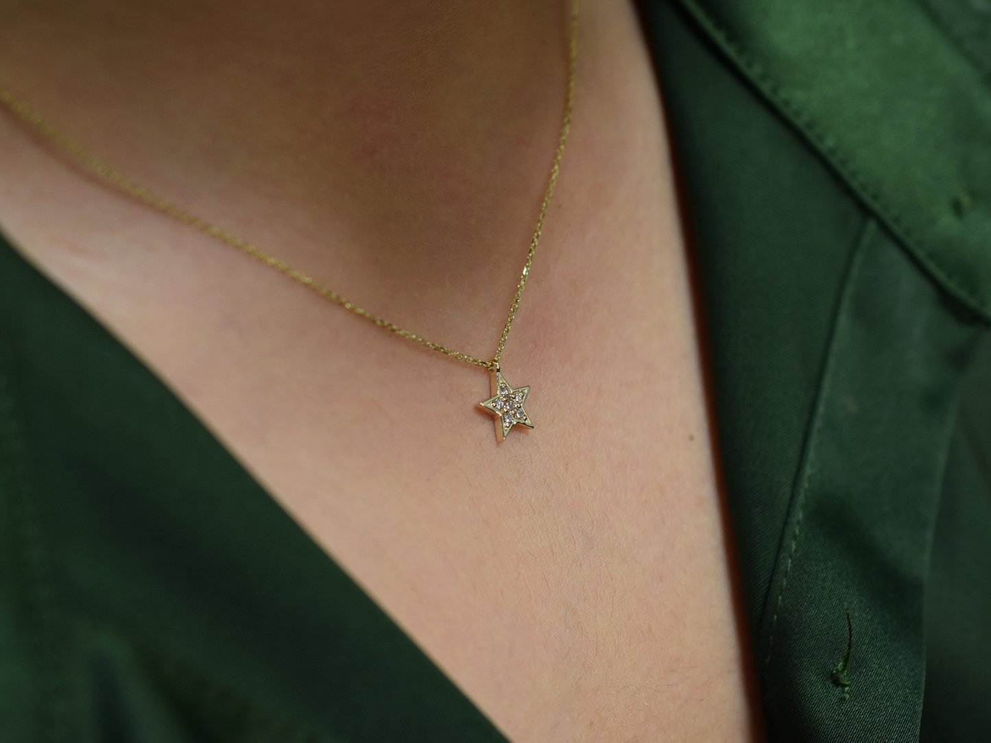 Minimalist celestial necklace with a star-shaped diamond pendant.