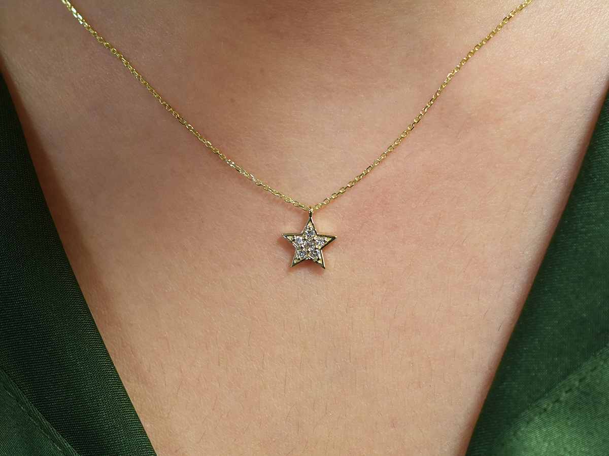 Elegant 14k gold star necklace for women, detailed view.