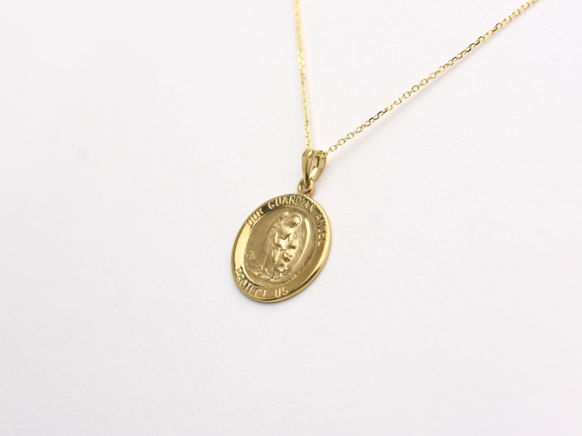 14k solid gold 17 mm Guardian Angel charm necklace .perfect for layering everyday look displayed on a white background . intended for all ages and for men and ladies