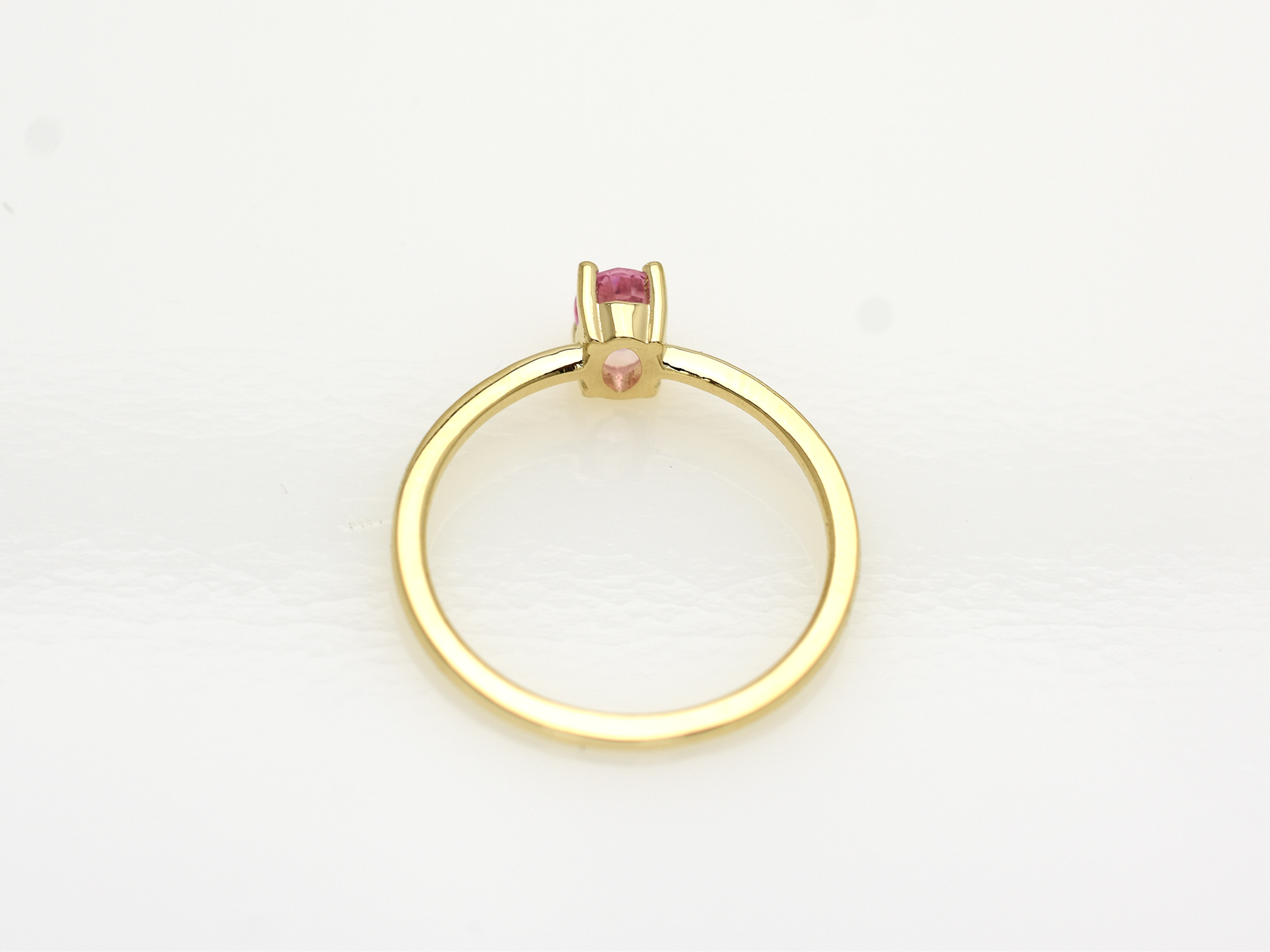 Natural pink sapphire ring in 14k gold with 0.56 carat oval stone, bottom view