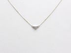  featuring a dainty three-stone diamond cluster pendant. The centerpiece consists of one slightly larger round brilliant cut stone flanked by two smaller stones in a minimalist prong setting on a fine gold cable chain with a lobster claw clasp