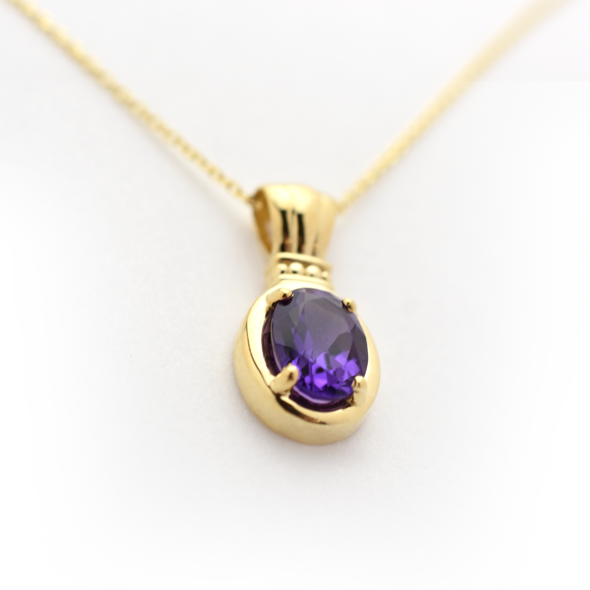 Close up oval amethyst pendant
