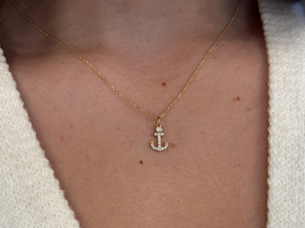 14k Gold and diamond Anchor necklace pendant with a 14k solid gold cable link chain, the diamonds are prong set and bezel set sliding on the chain displayed on a white background