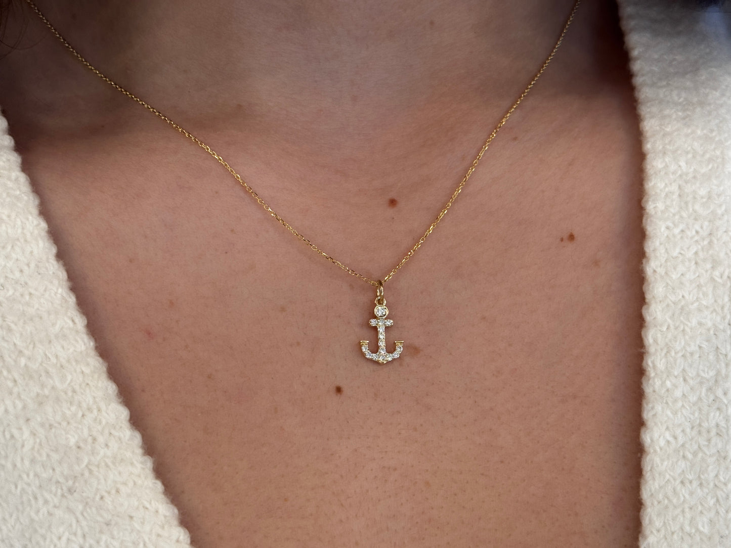 14k Gold and diamond Anchor necklace pendant with a 14k solid gold cable link chain, the diamonds are prong set and bezel set sliding on the chain displayed on a white background