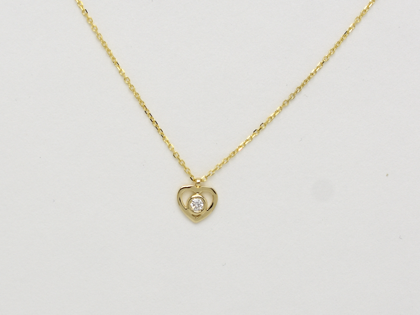 14k solid gold Heart necklace with one diamond in the center