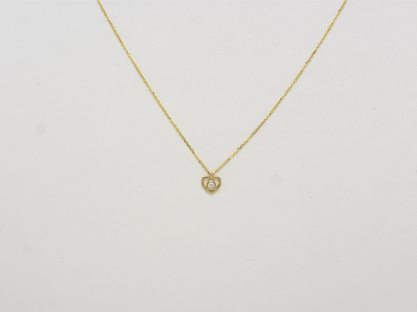 14k solid gold Heart necklace with one diamond in the center