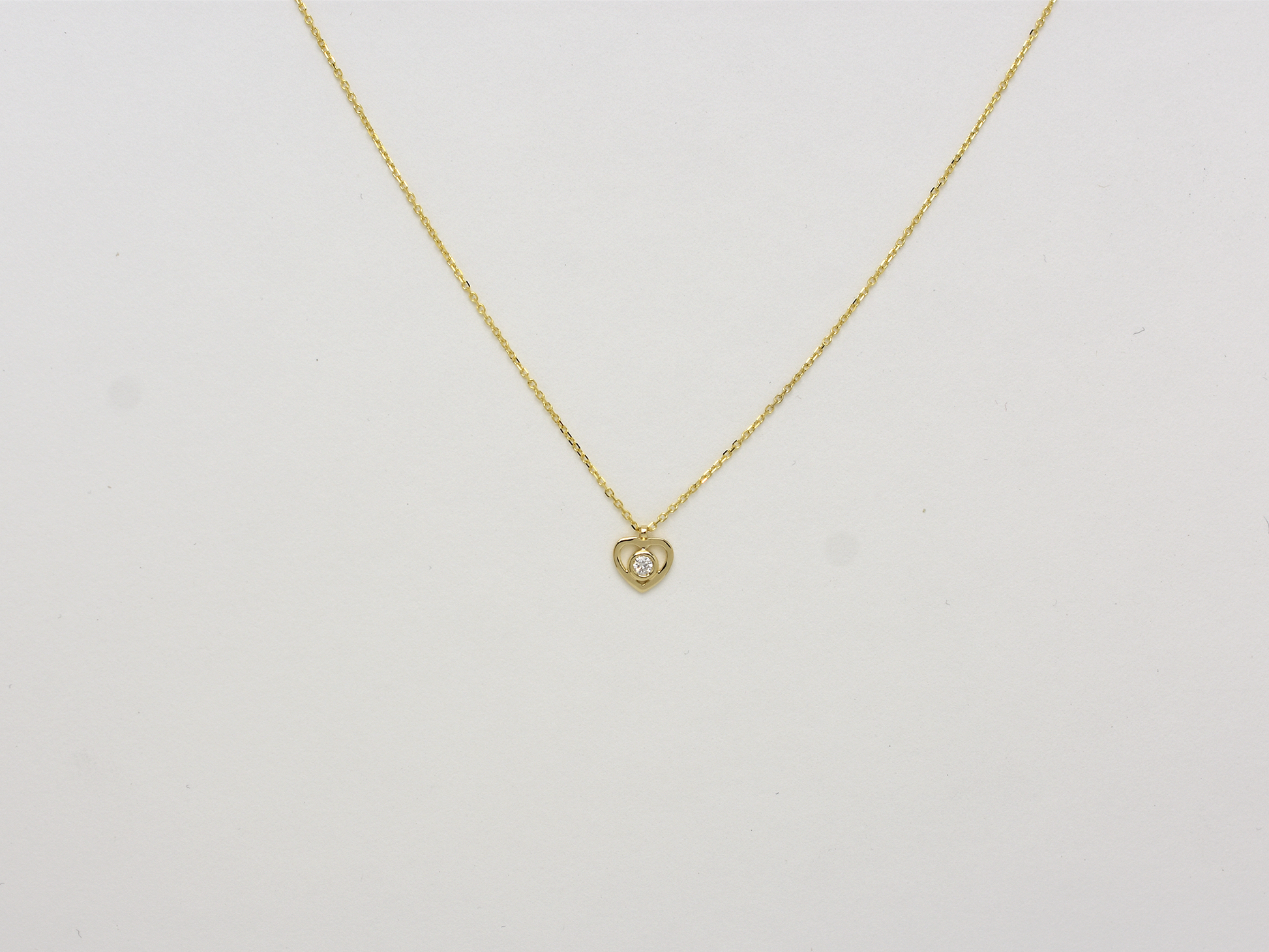 14k solid gold Heart necklace with one diamond in the center