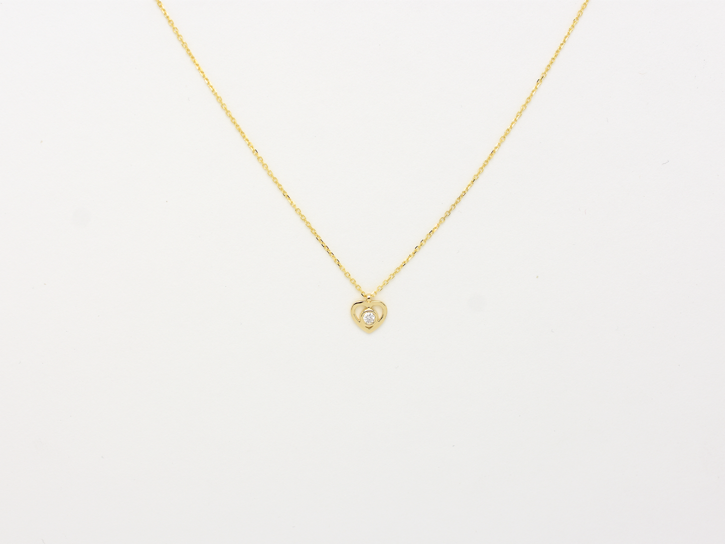 14k solid gold Heart necklace with one diamond in the center