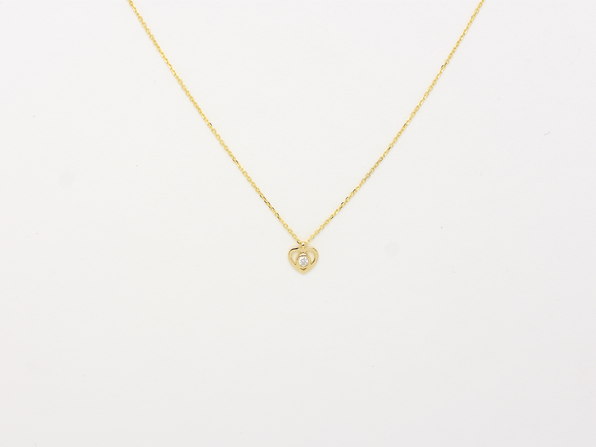 14k solid gold Heart necklace with one diamond in the center