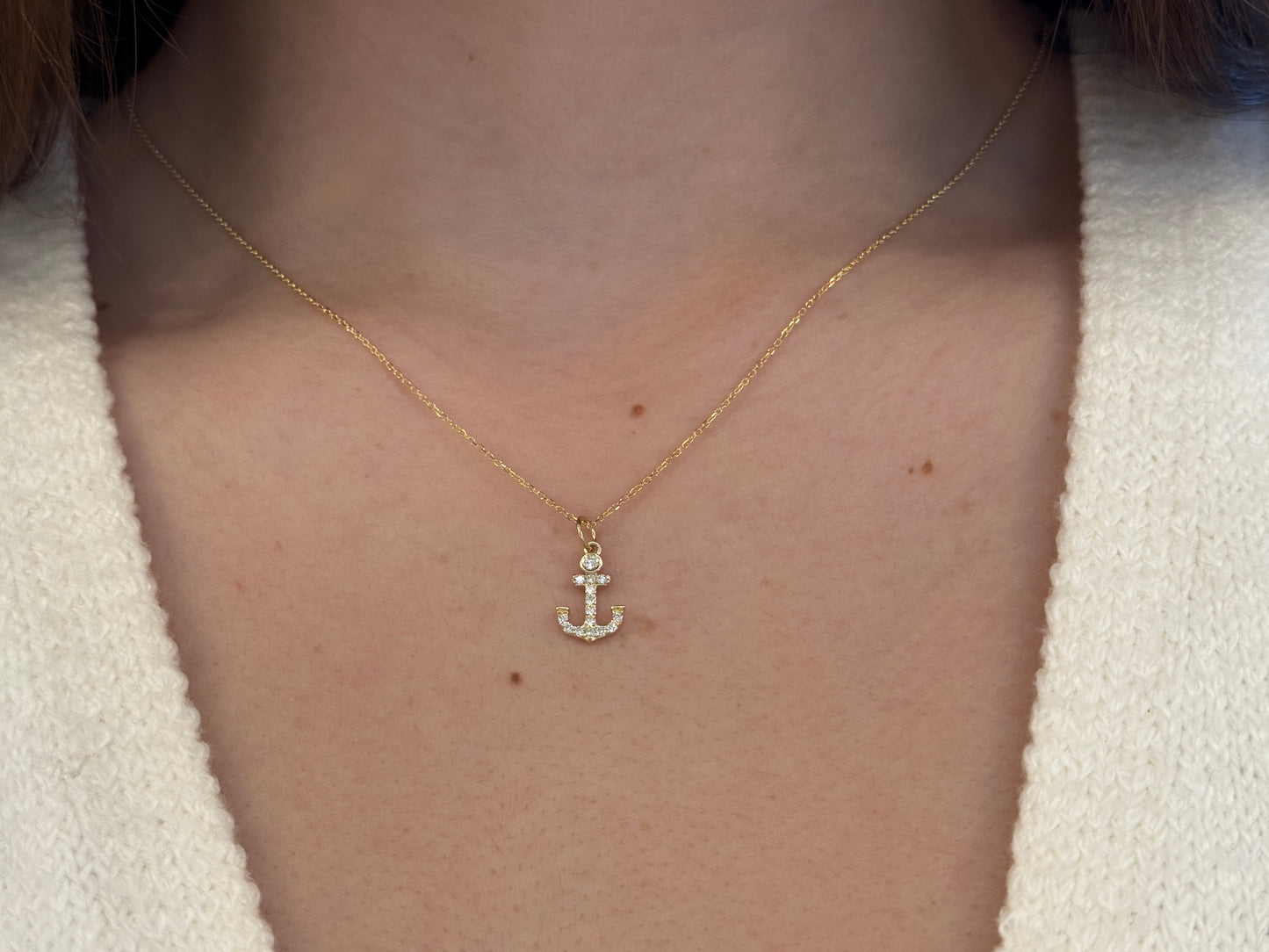 14k Gold and diamond Anchor necklace pendant with a 14k solid gold cable link chain, the diamonds are prong set and bezel set sliding on the chain displayed on a white background
