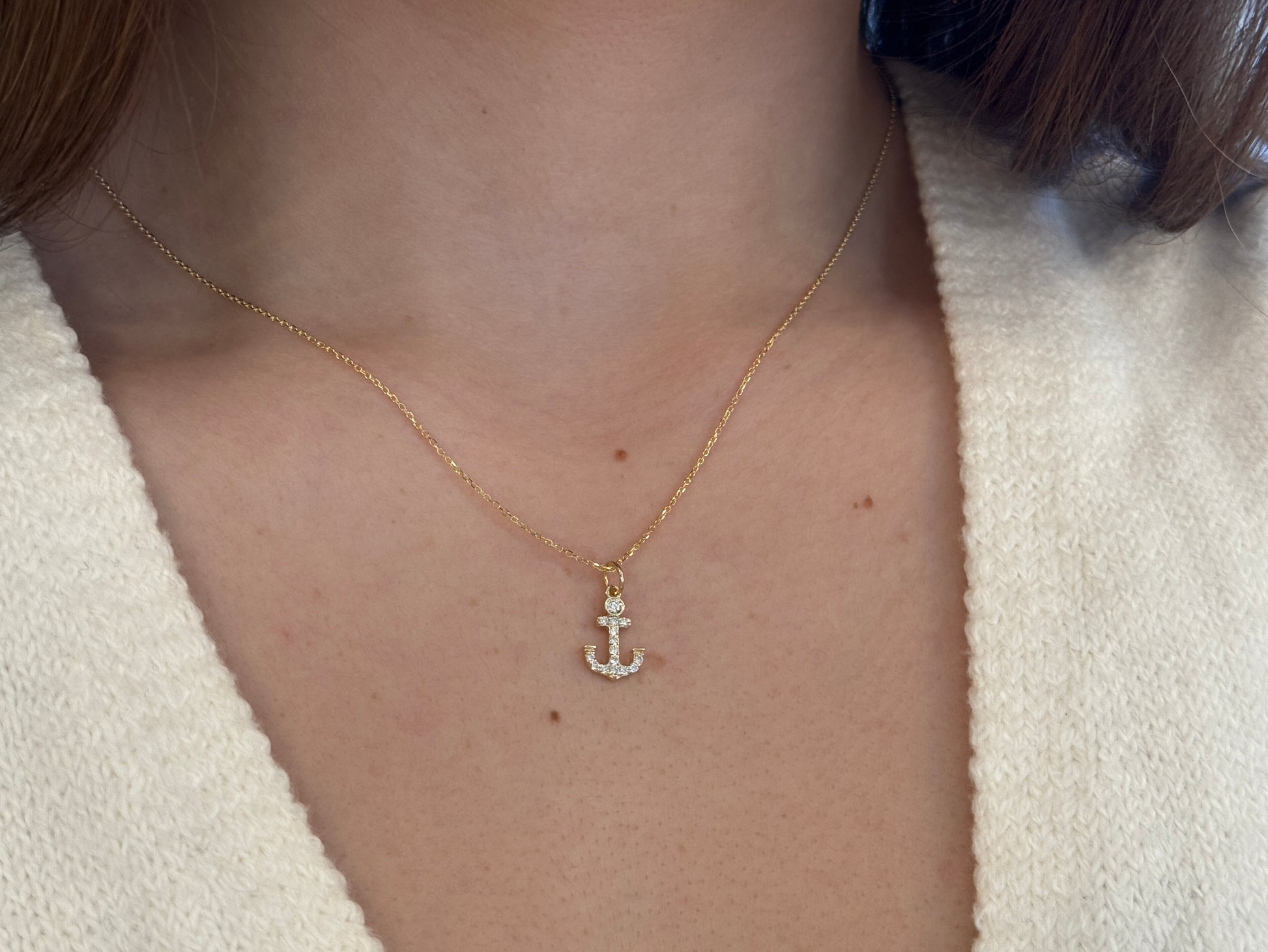 14k Gold and diamond Anchor necklace pendant with a 14k solid gold cable link chain, the diamonds are prong set and bezel set sliding on the chain displayed on a white background