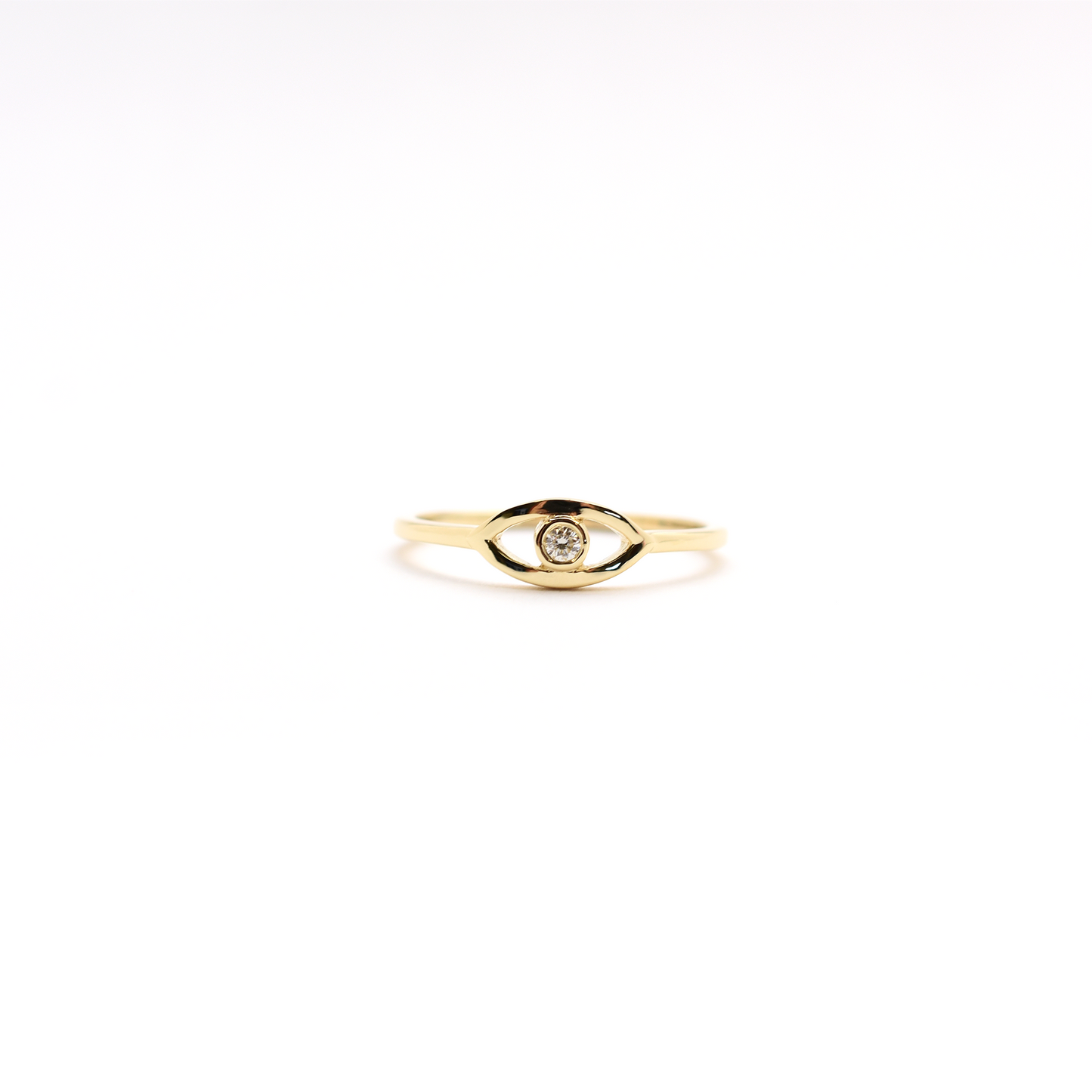 A 14K yellow gold ring featuring a round diamond set in a white gold band, known as the 'Diamond Evil Eye'.