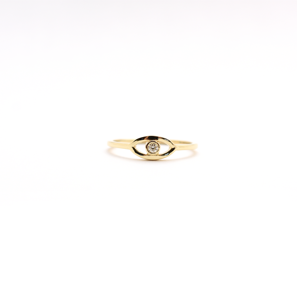 A 14K yellow gold ring featuring a round diamond set in a white gold band, known as the 'Diamond Evil Eye'.