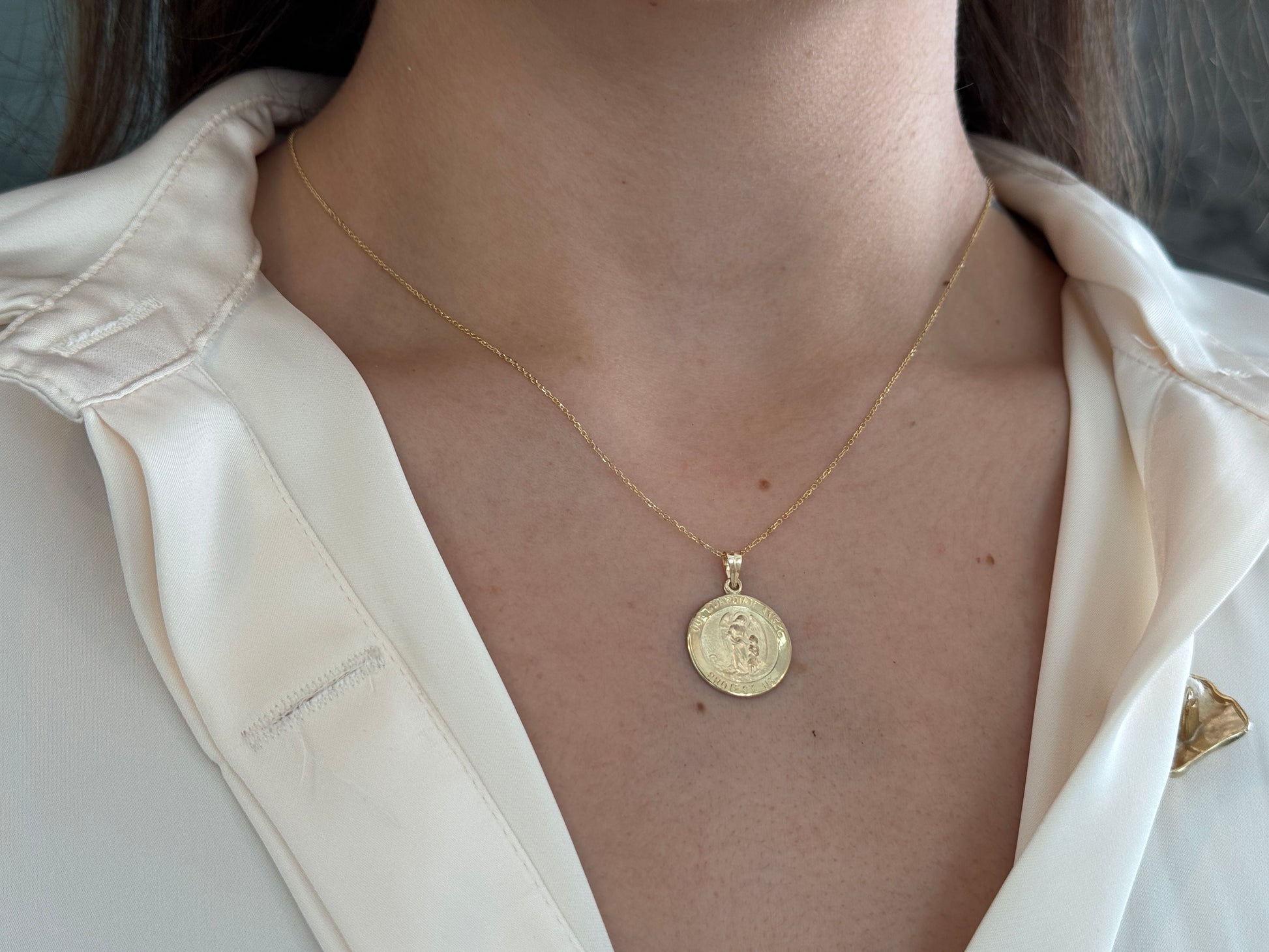 14k solid gold 17 mm Guardian Angel charm necklace .perfect for layering everyday look displayed on a Model with a white shirt . intended for all ages and for men and ladies