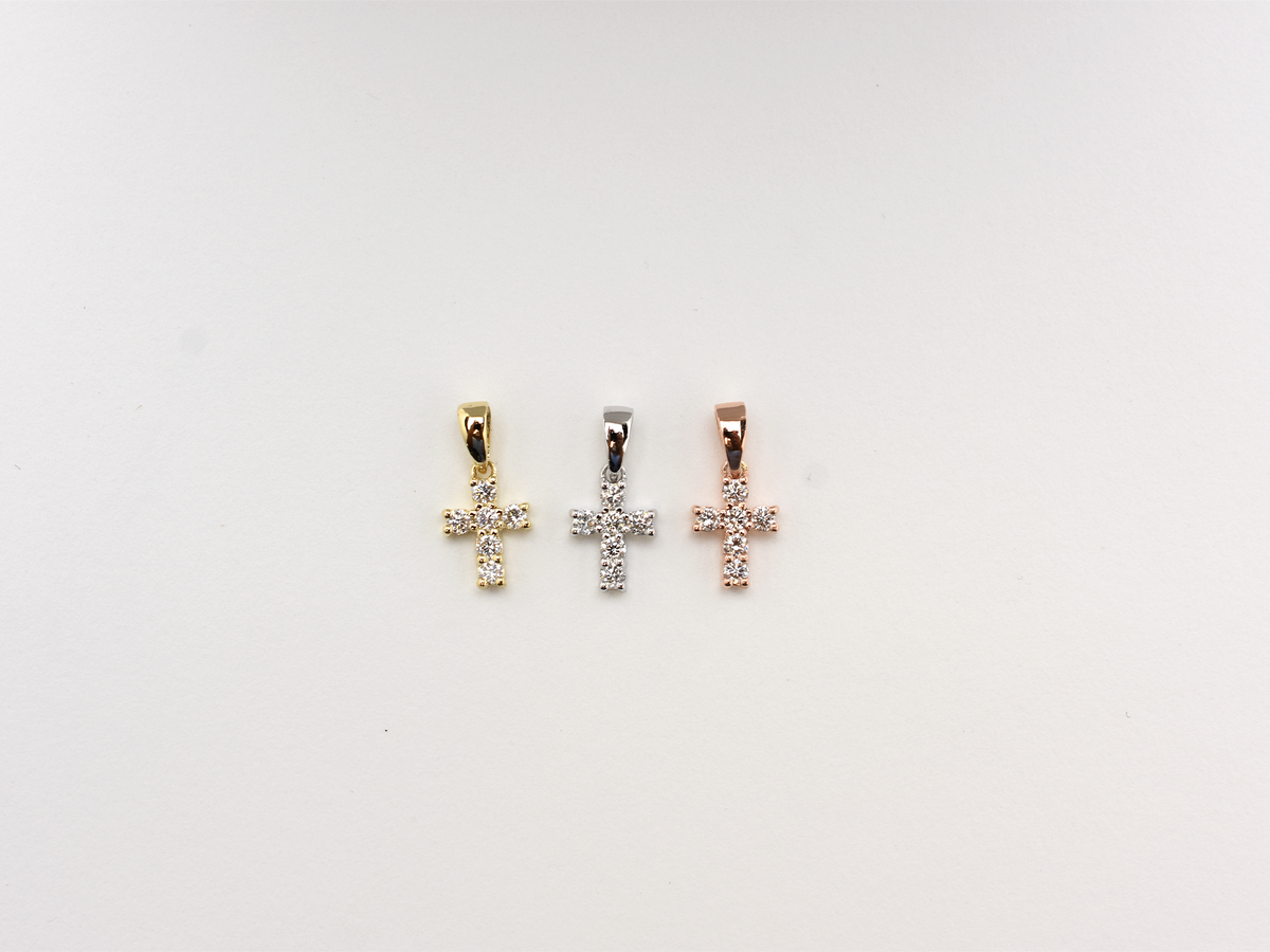 14K gold diamond cross pendant on display