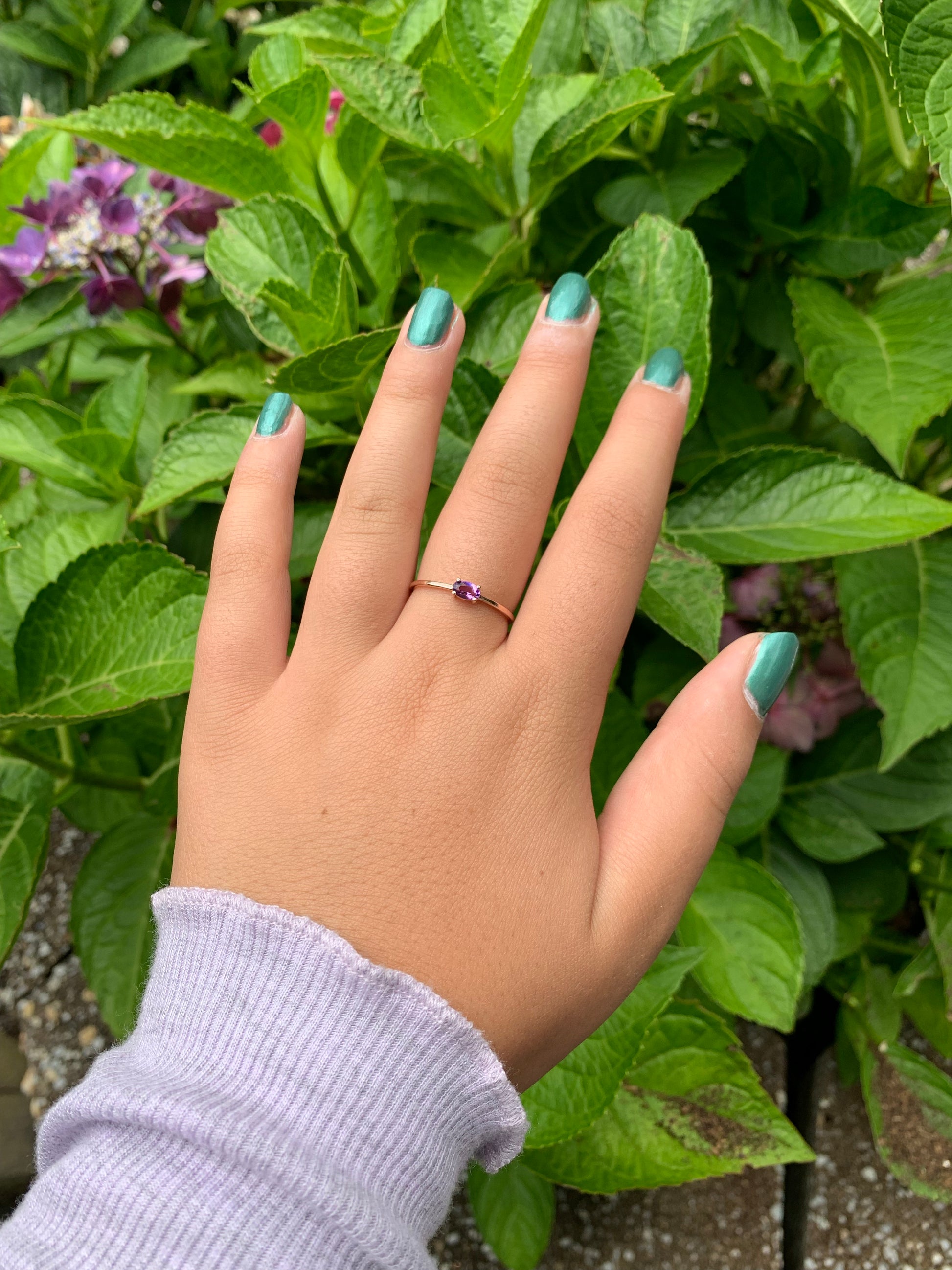 14k gold and oval solitaire ring on hand