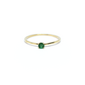 A 14K gold round emerald ring with a single emerald stone on a white background.