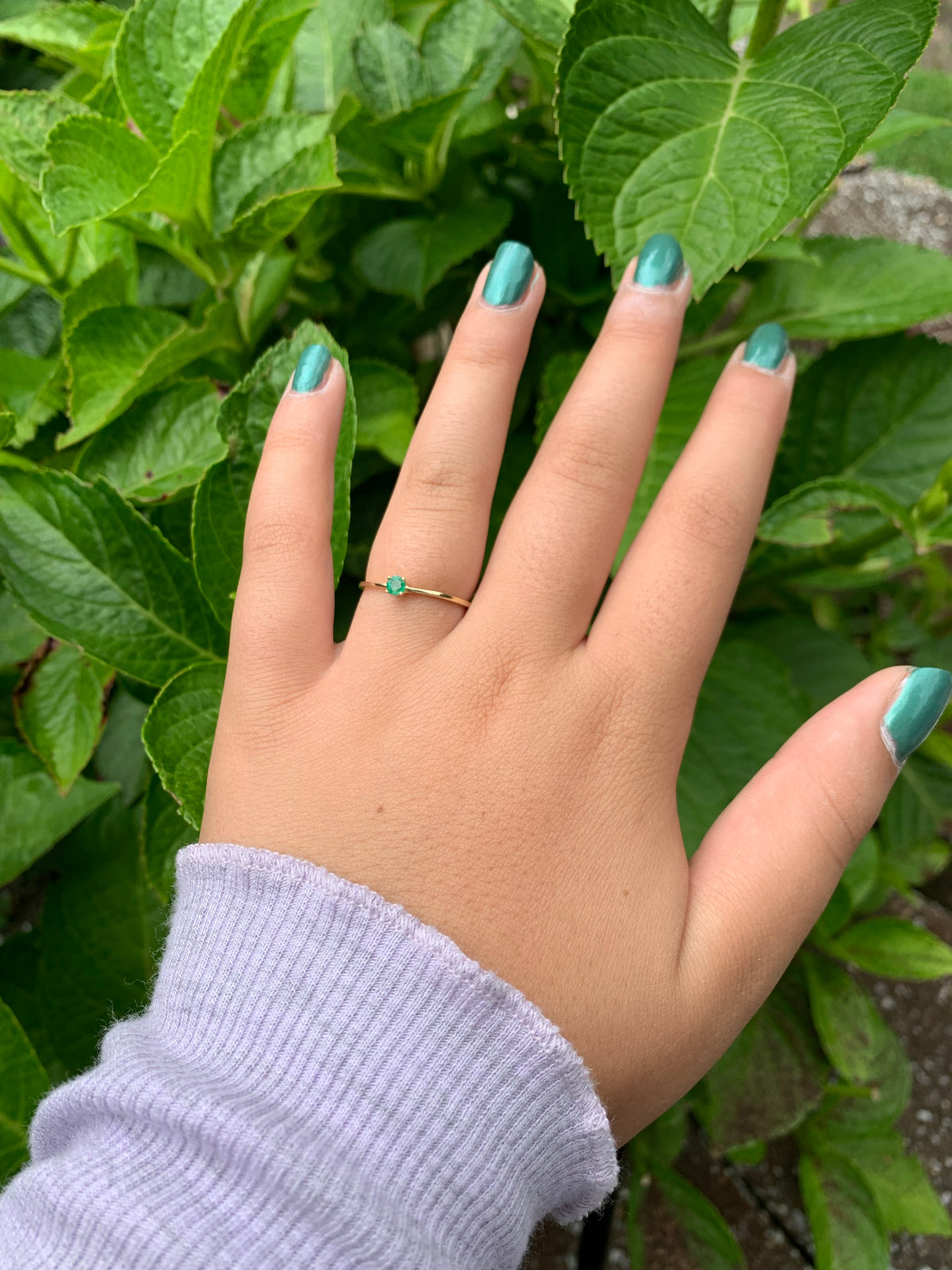 dainty 14l gold emerald ring on finger