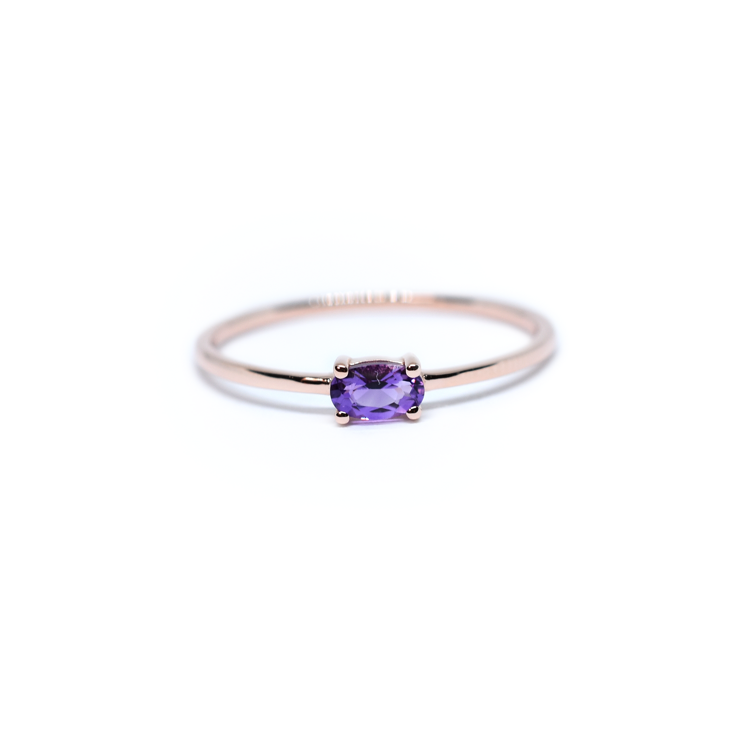 14k gold and oval solitaire ring in white background