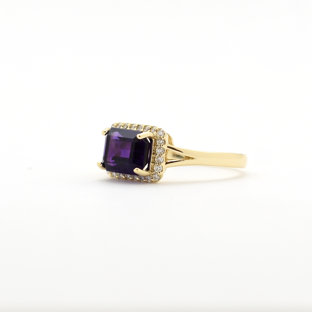 14k yellow gold emerald-cut amethyst ring with diamond halo on a gold band, elegant birthstone jewelry"