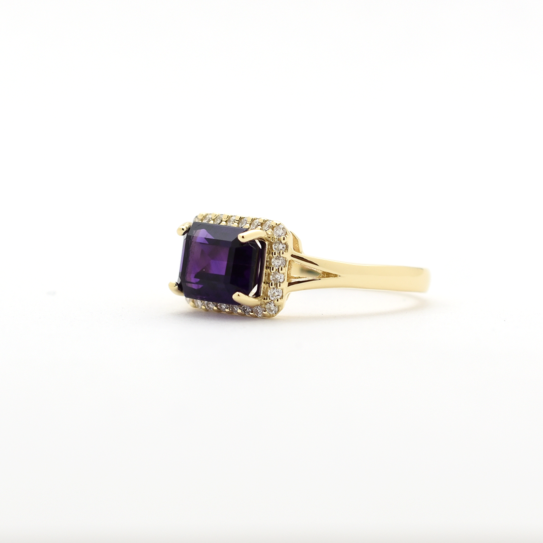 14k yellow gold emerald-cut amethyst ring with diamond halo on a gold band, elegant birthstone jewelry"