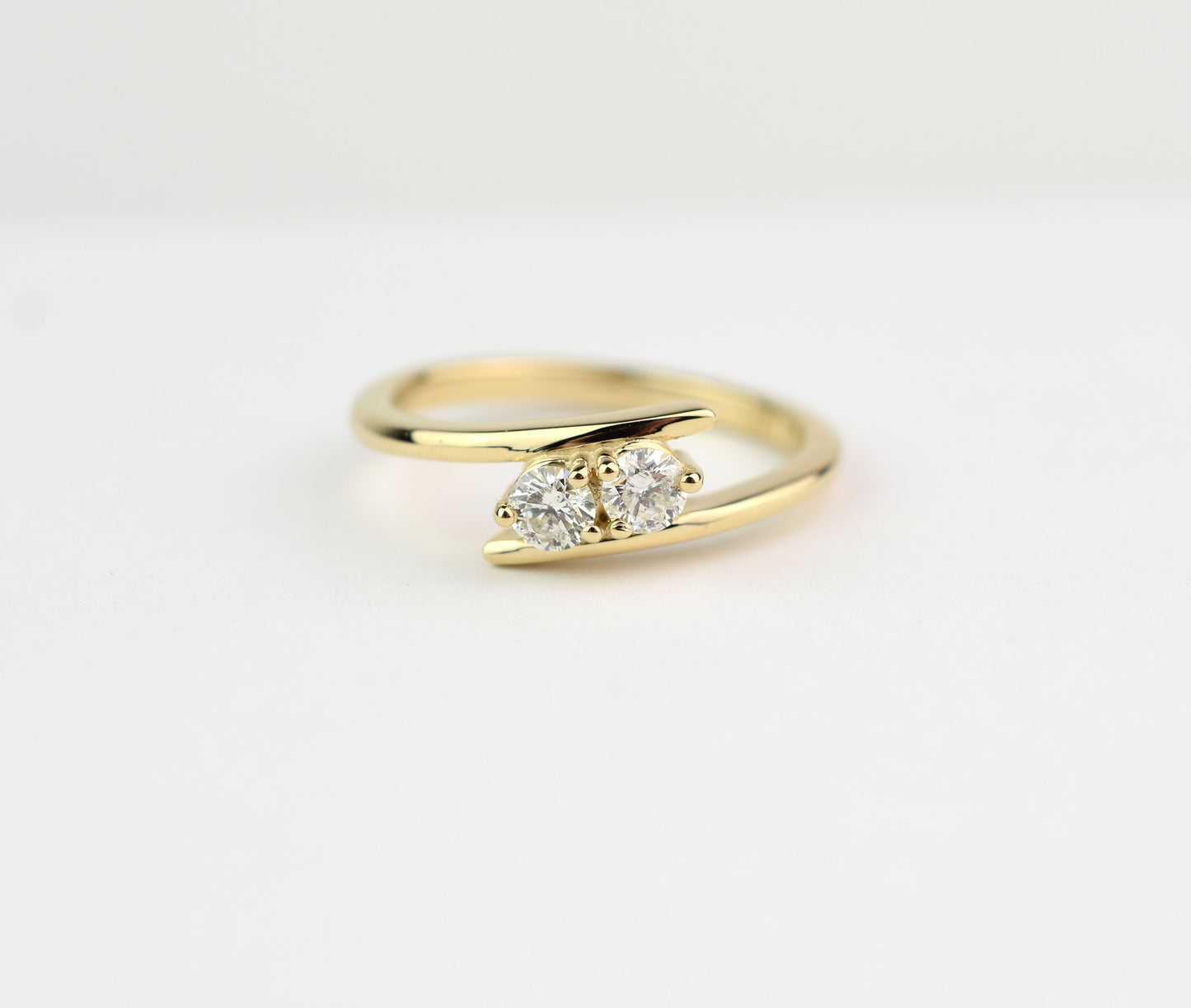 14k yellow gold two-stone diamond bypass ring with round-cut natural diamonds, elegant anniversary jewelry"