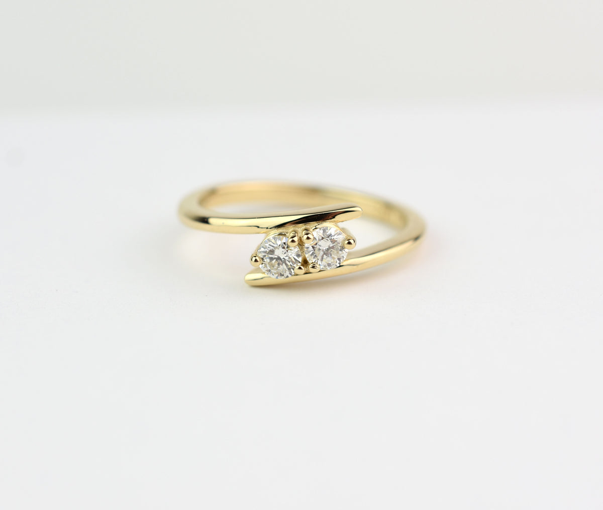 14k yellow gold two-stone diamond bypass ring with round-cut natural diamonds, elegant anniversary jewelry"